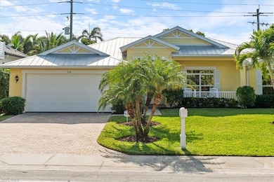 View of front of home with a porch, a garage, and 