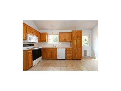 Kitchen has tile floor, wood cabinets and pantry