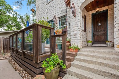 Doorway to property featuring stone siding and fe