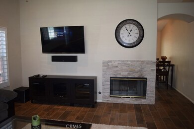 Portion of family room with arched entry to kitchen and dining