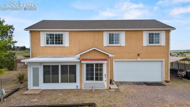 Back of property featuring a garage