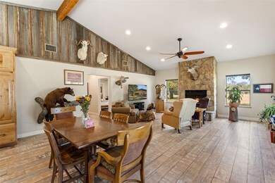 Dining space featuring beam ceiling, a fireplace,