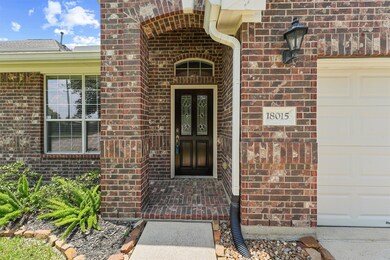 A closer look at the entrance reveals elegant glass panels on the front door, adding a touch of sophistication. The home's address is prominently displayed, ensuring easy identification for guests and deliveries.