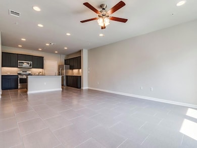 Unfurnished living room featuring a ceiling fan a