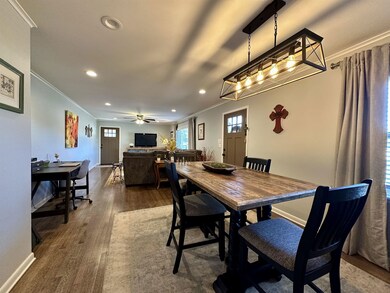 Dining area with ceiling fan, crown molding, and d