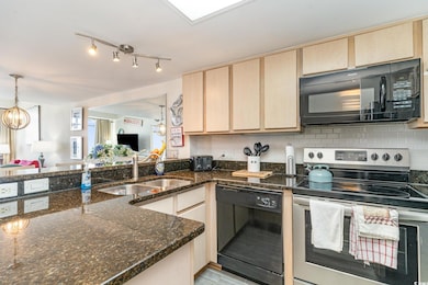 Kitchen with tasteful backsplash, open floor plan,