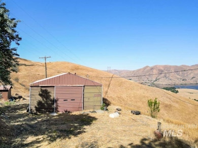View of yard with an outdoor structure, a mountain view, and a detached garage