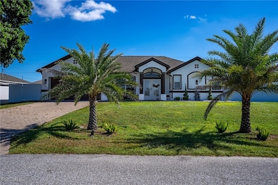 View of front of property with a front lawn, stucco siding, and driveway