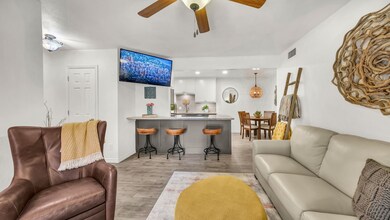 Living room with light wood-style floors, a ceiling fan, and recessed lighting