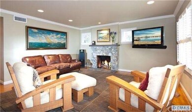 Living room with hardwood flooring, fireplace, lea