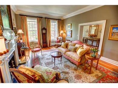 Formal Living Room with hardwood floors, elaborate crown molding, fireplace with marble surround and mantel is replica from John Marshall house