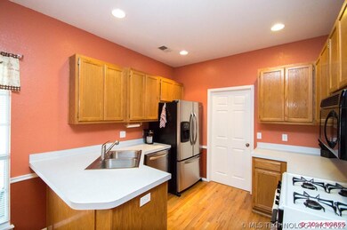 The kitchen has plenty of cabinets, canned lightin