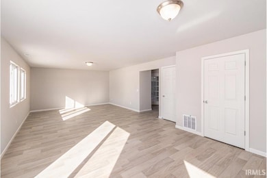 The massive great room features multiple windows o