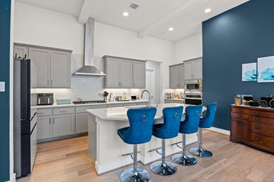 Kitchen featuring gray cabinetry, stainless steel