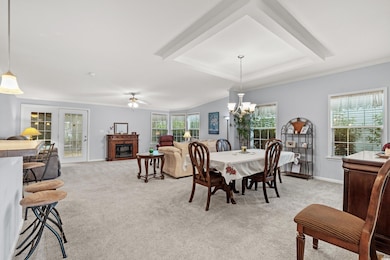 Dining area with ornamental molding, ceiling fan w