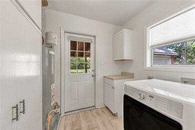 Laundry room featuring washer / dryer, cabinet spa
