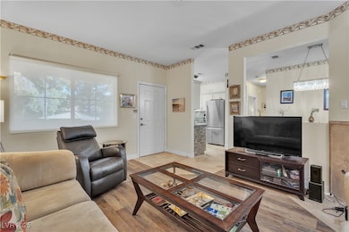 Living room with light wood finished floors and baseboards