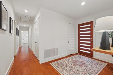 Foyer featuring visible vents, wood finished floor