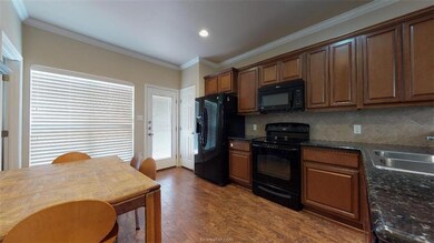 Kitchen featuring a sink, decorative backsplash, b