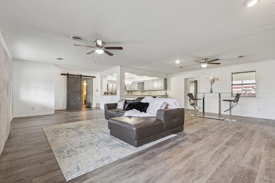 Living room with ceiling fan, a textured ceiling, 