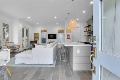 Living room featuring light wood-style flooring and recessed lighting
