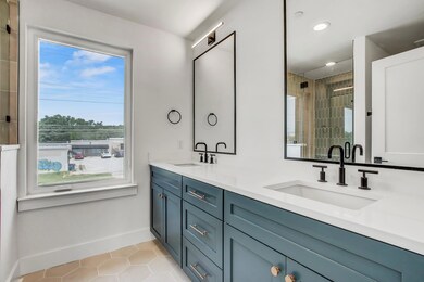 Bathroom with tile patterned flooring, baseboards