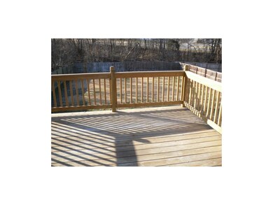 Large deck overlooks fenced back yard