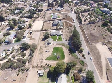An aerial shot showing the two acre parcel, neighb