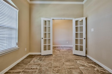 Tiled spare room with french doors, crown molding, and plenty of natural light