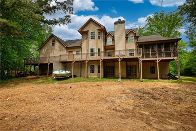 Rear view of house with a sunroom, a wooden deck, 