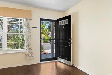 Foyer with a healthy amount of sunlight and wood-t