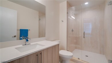 Bathroom with vanity, toilet, and walk in shower