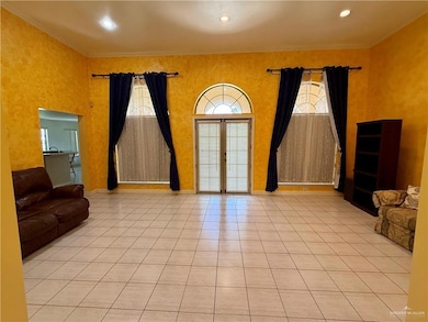 Living Room with arched walkways, light tile patterned floors, a towering ceiling, and crown molding