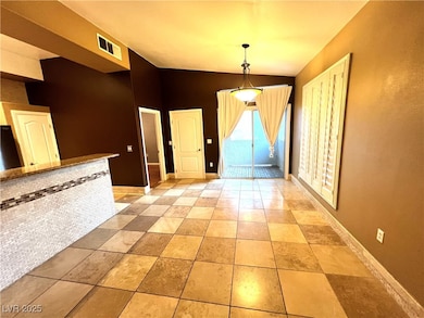 Unfurnished dining area with lofted ceiling and light tile patterned floors