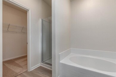 The spacious master bathroom showcases a soaker tu