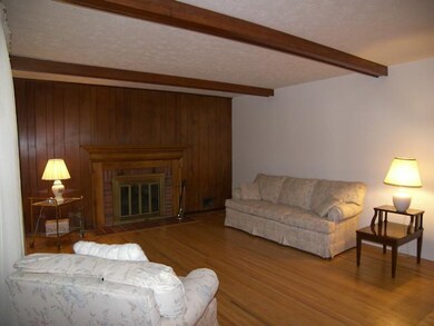 Living Room Beamed ceiling and fireplace will make