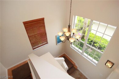 Stairway with a healthy amount of sunlight and a high ceiling