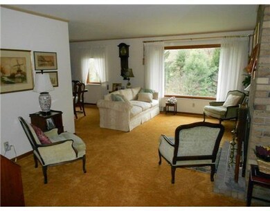 Living Room. Hardwood under carpet. Newer windows 