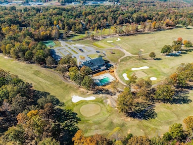 Aerial overview of property's location with a golf course