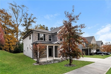 Traditional-style home featuring a front lawn and brick siding