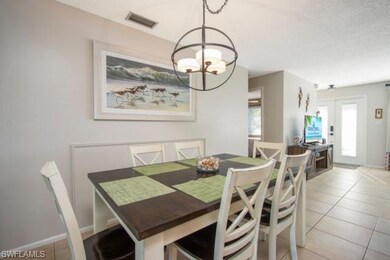 Dining area featuring light tile patterned flooring and a chandelier