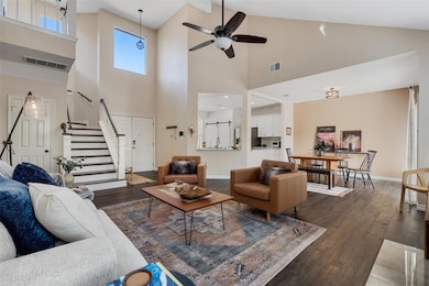 The living room seamlessly connects to the kitchen and dining room, fostering an open and inclusive atmosphere for effortless socializing and shared experiences.