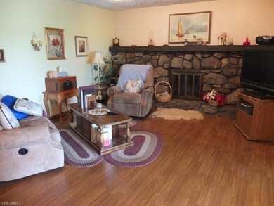 Family room with stone fireplace and access to sun