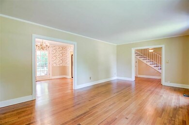 Living Room has large doorways and original hardwo
