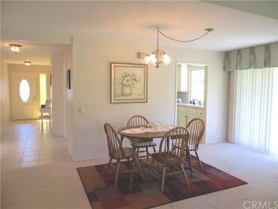 View of dining room includes entry and kitchen