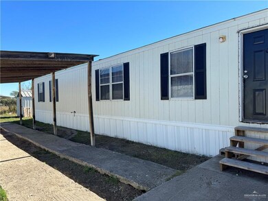 View of side of property featuring a carport