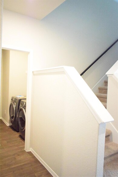 Staircase featuring independent washer and dryer 