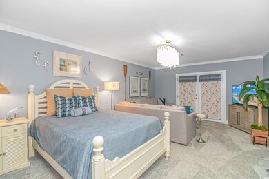 Carpeted bedroom featuring ornamental molding