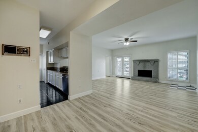 Open living area with light wood flooring and a ce
