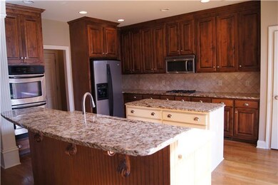 Kitchen offers tons of counterspace, gas cooktop, granite countertops, island, under cabinet lighting